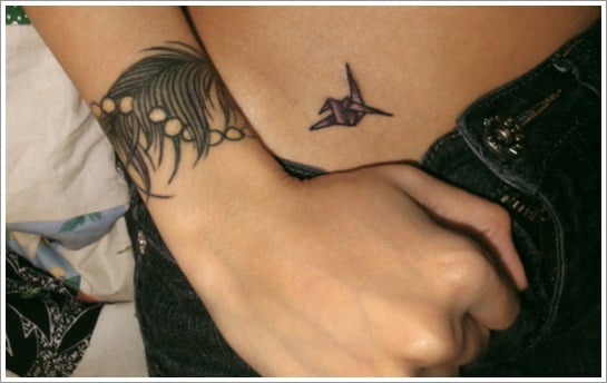 Wrist tattoo of a feather on Sydney